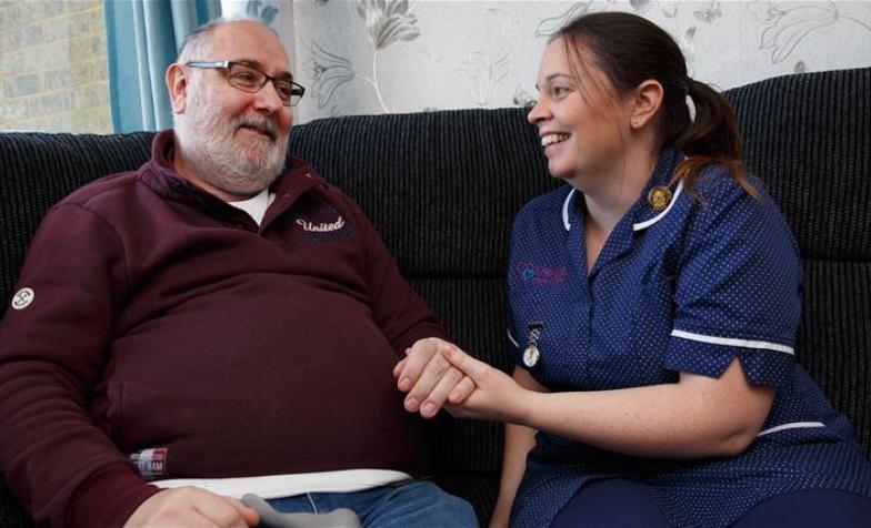 A photo of someone receiving home care by a hospice nurse