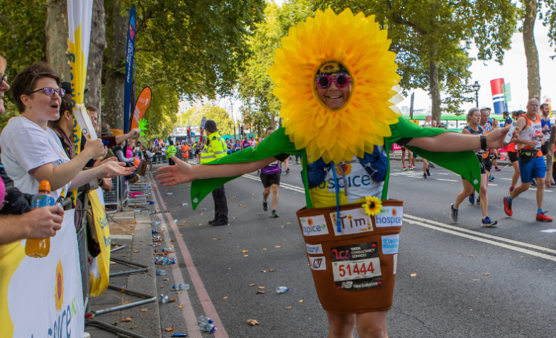 Male runner dressed as sunflower at cheer station