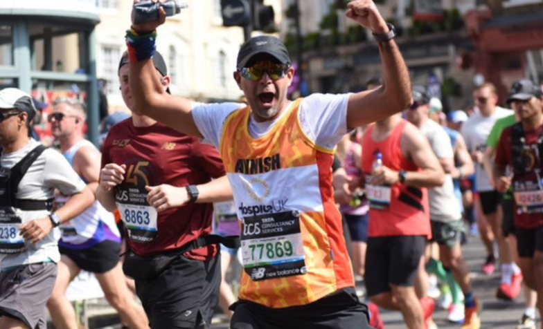 Man running with his arms in the air, smiling