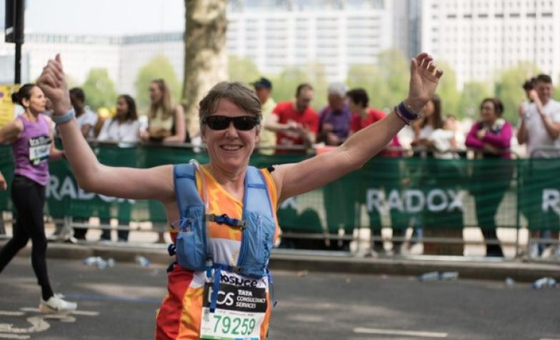 Runner celebrating with arms in the air