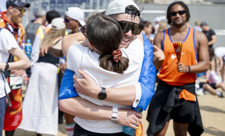 A runner hugging a friend