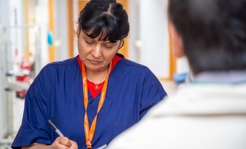 A nurse recording clinical outcomes