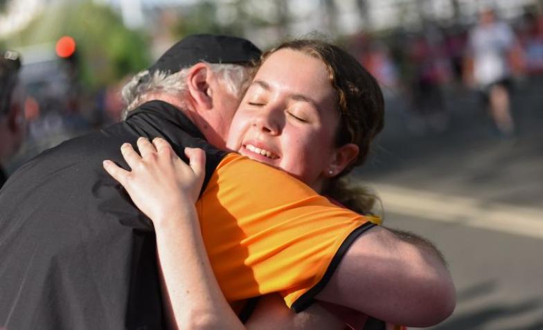 Hospice UK runner hugging their family member