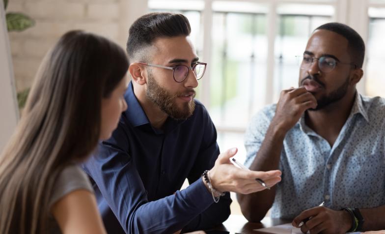 Three at work having a discussion
