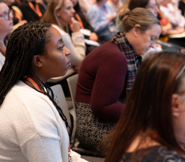 Close-up of people listening in a session at National Conference