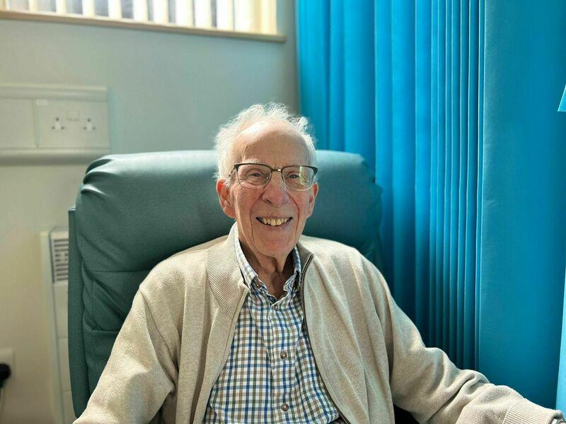 Hospice patient Roger smiling in the inpatient unit