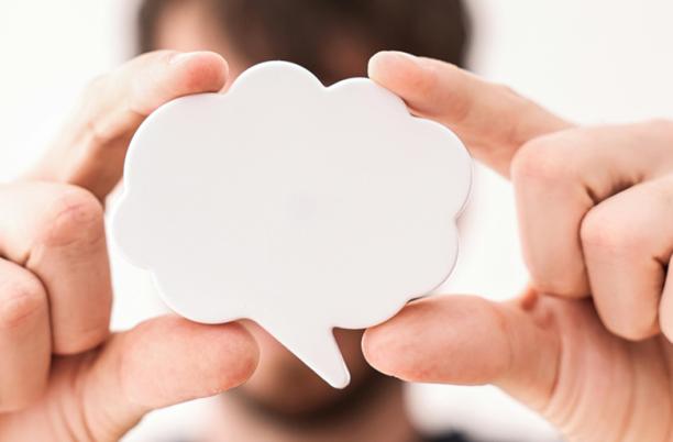 A stock photo from Pexels depicting a man holding up a speech bubble