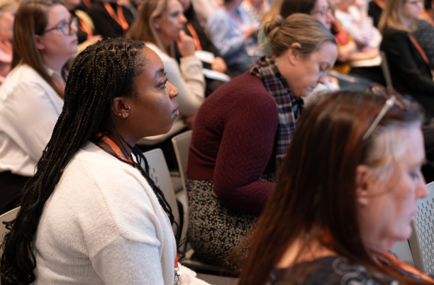 Close-up of people listening in a session at National Conference