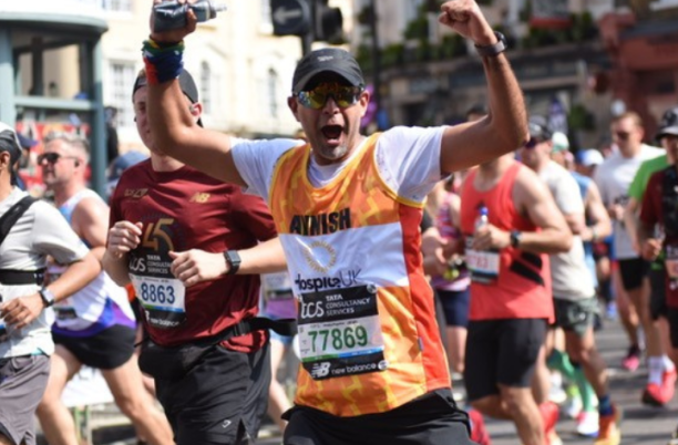 Man running with his arms in the air, smiling