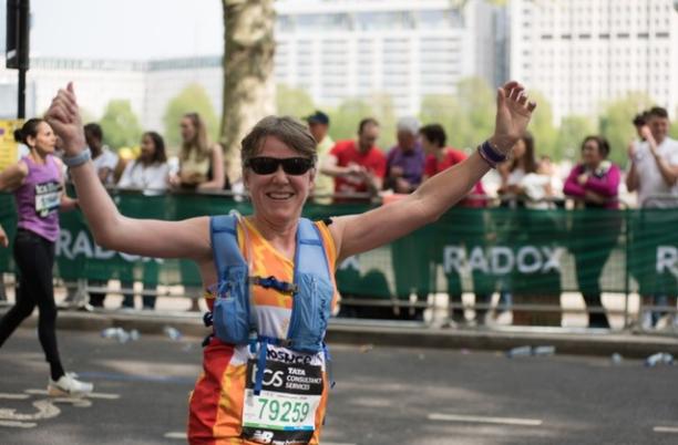 Runner celebrating with arms in the air