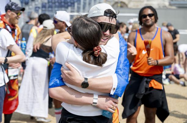 A runner hugging a friend