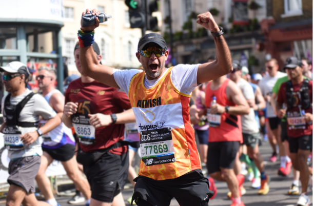 Marathon runner celebrates toward the camara while running