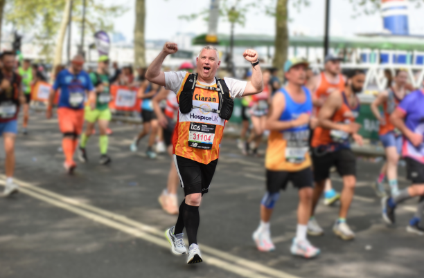 Hospice UK runner celebrating during a race