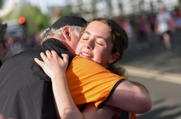Hospice UK runner hugging their family member