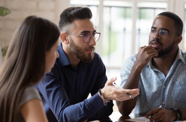 Three at work having a discussion
