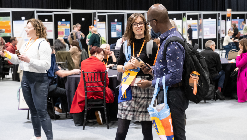Two people talking in a conference exhibition space
