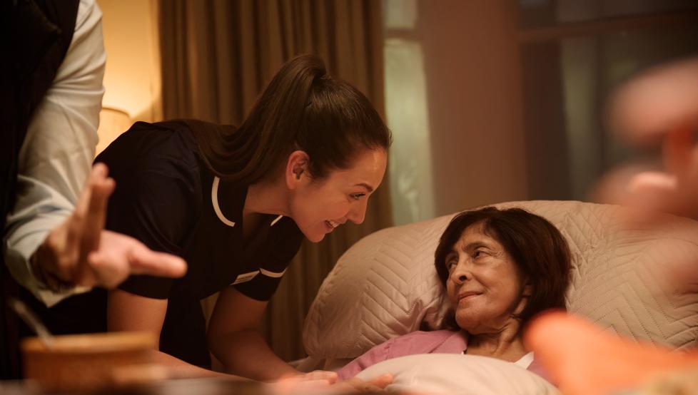 From This is Hospice Care legacy campaign - woman in bed at her home with hospice nurse by her side