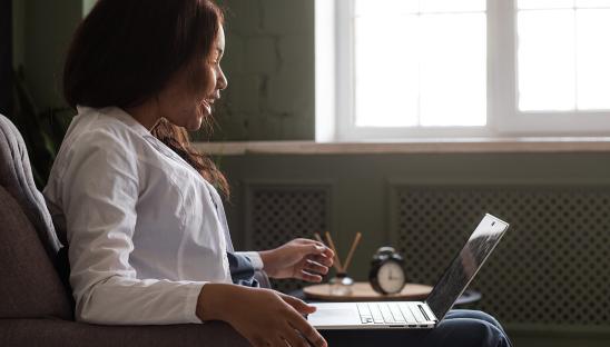Woman at an event on her laptop